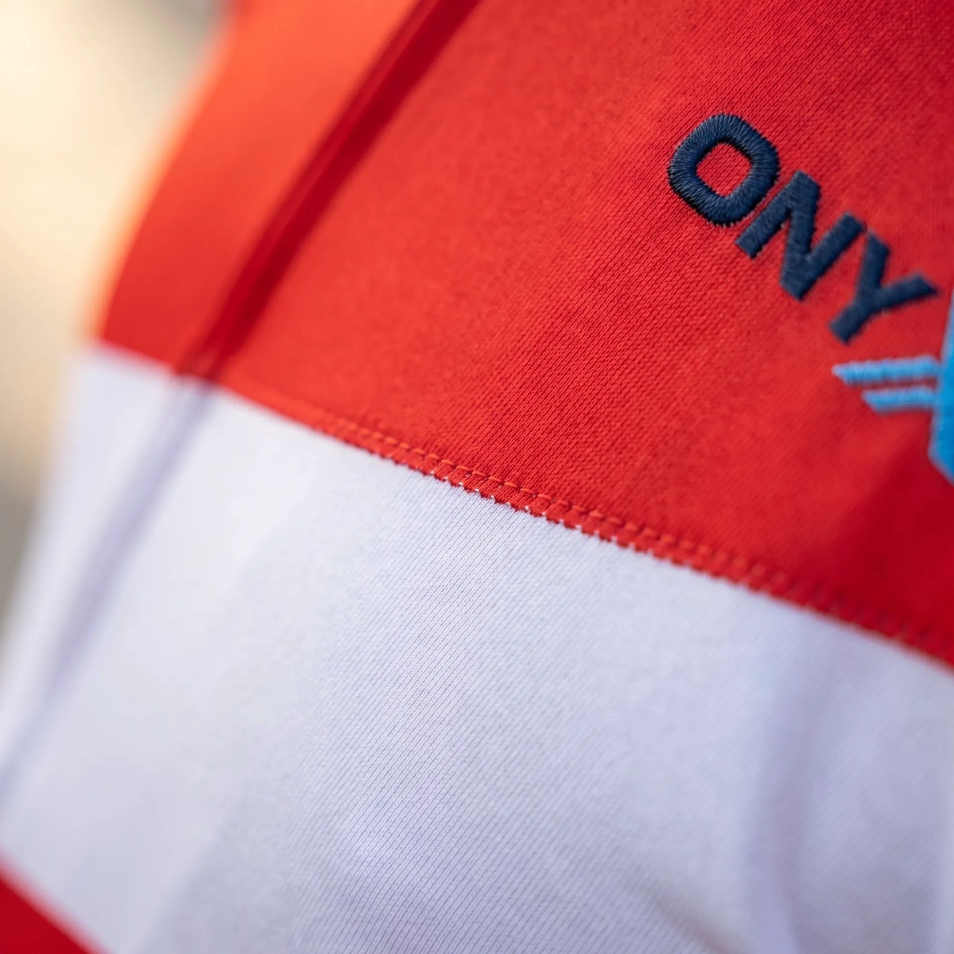 Macro detail of fabric, stitching and logo on the Echelon Race Jersey