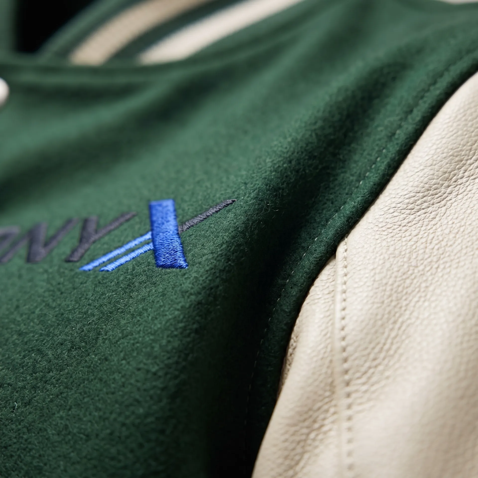 Macro detail of fabric, stitching and logo on the Letterman Varsity Jacket