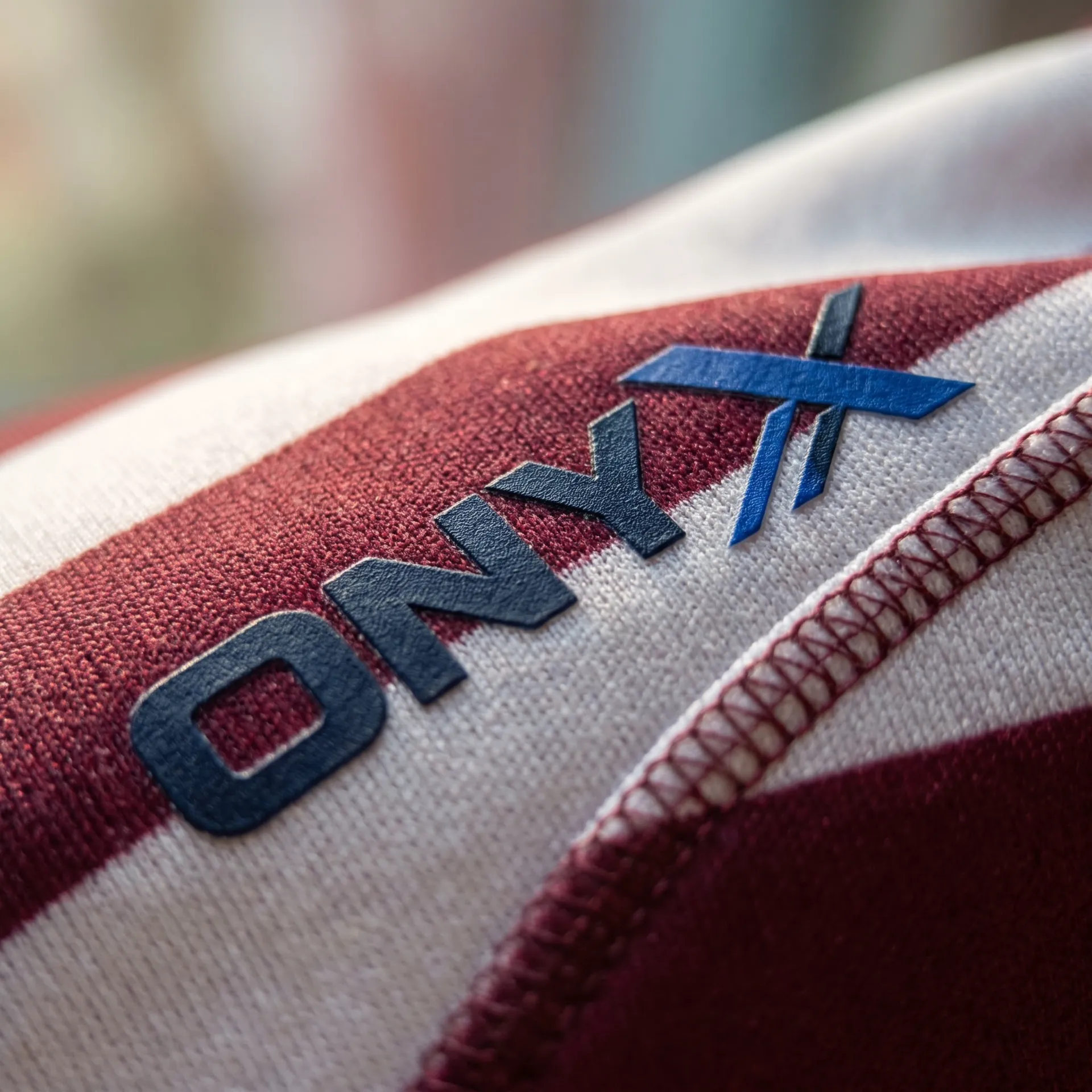 Macro detail of fabric, stitching and logo on the Breakdown Hooped Jersey