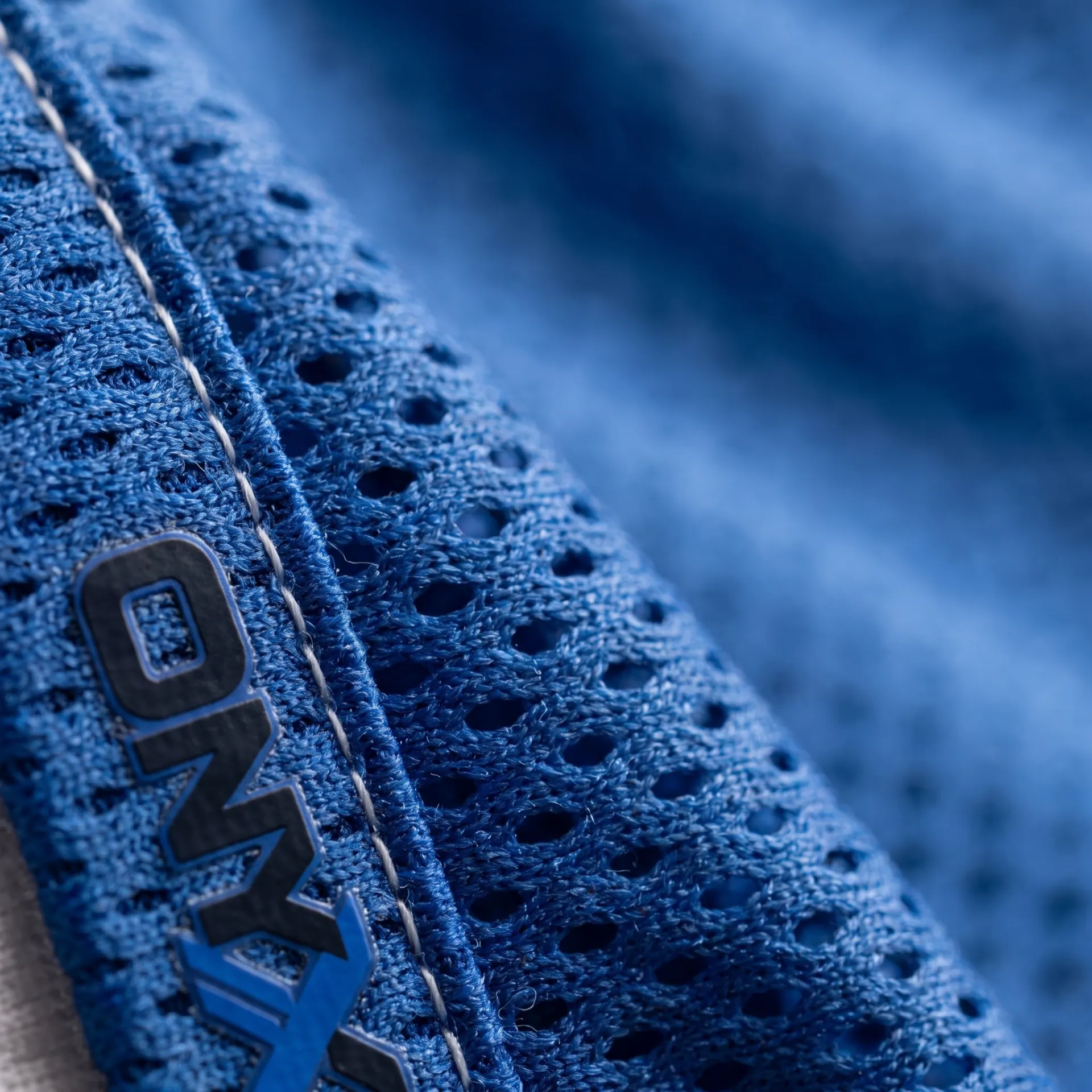 Macro detail of fabric, stitching and logo on the Double-Mesh Shorts