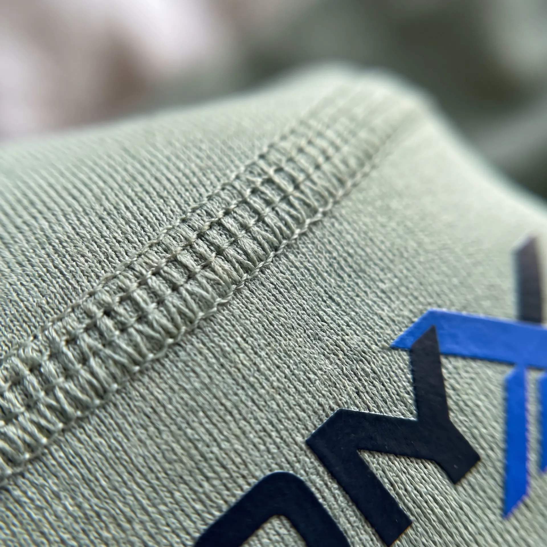 Macro detail of fabric, stitching and logo on the Still High-Waist Leggings