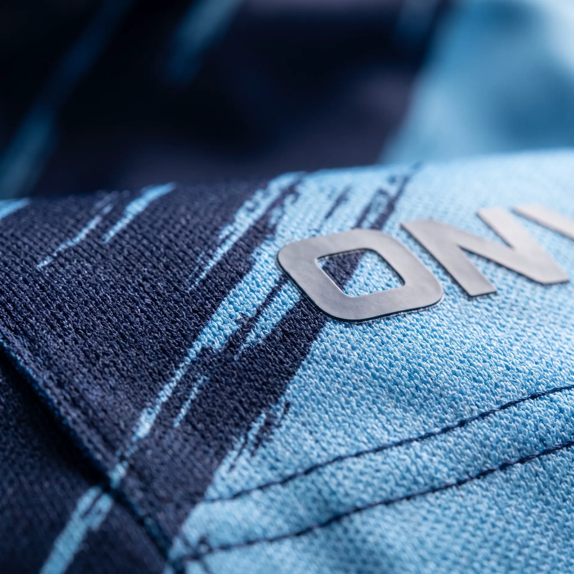Macro detail of fabric, stitching and logo on the Powerplay T20 Shirt