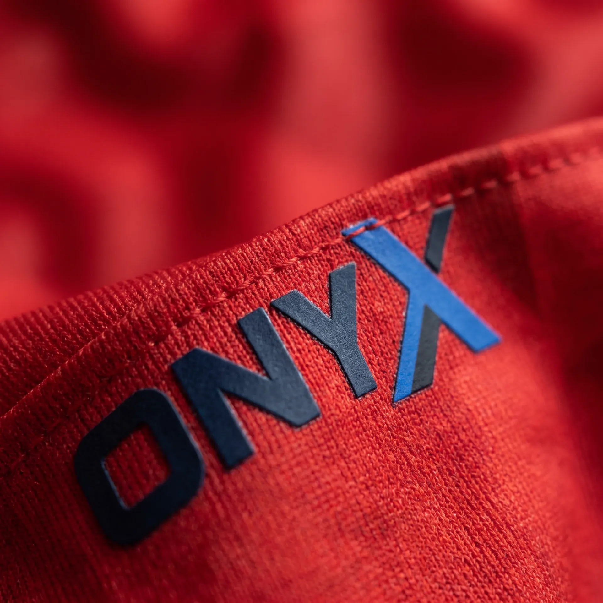 Macro detail of fabric, stitching and logo on the Strike Match Jersey